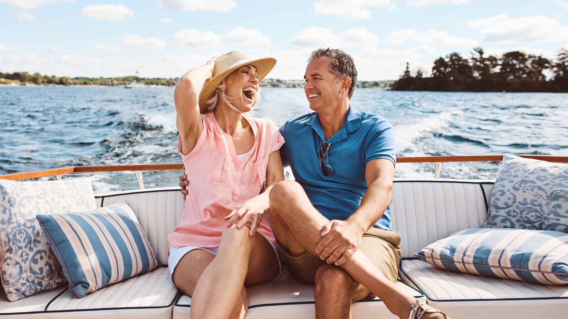 Discover mature couple enjoying a relaxing boat ride, much-needed vacation or their early retirement years.