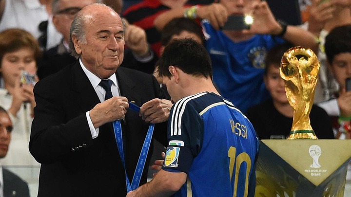 Messi receives his silver medal from Blattter at 2014 world cup (Photo Credit: Goal)