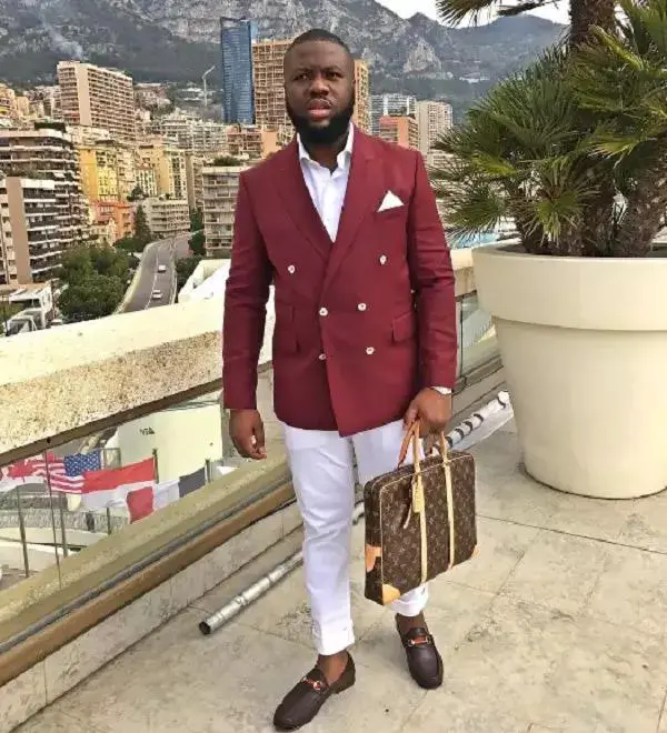 Hushpuppi in suite carrying designer bag