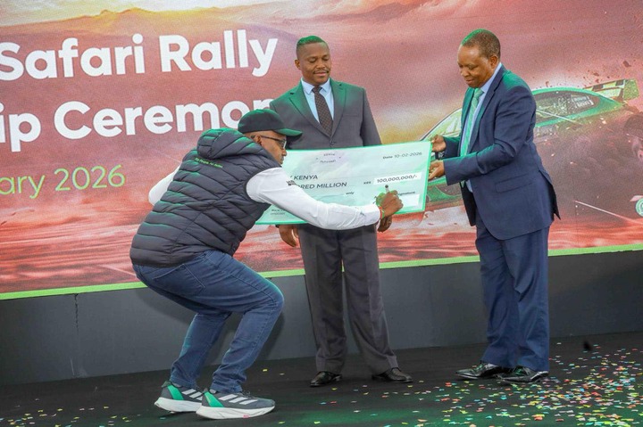 May be an image of dais and text that says 'Safari Rally p Ceremo ary 2026 SAD OTA 10-02-2076 究 は "KENYA RED KEMILLION REDMILLION MILLION 100,000,000/'