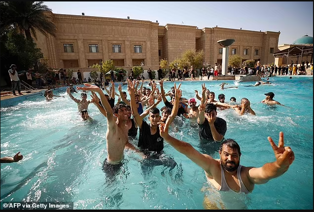  Violent clashes leave 23 dead after protesters storm Iraqi government palace and stage impromptu pool party (photos)