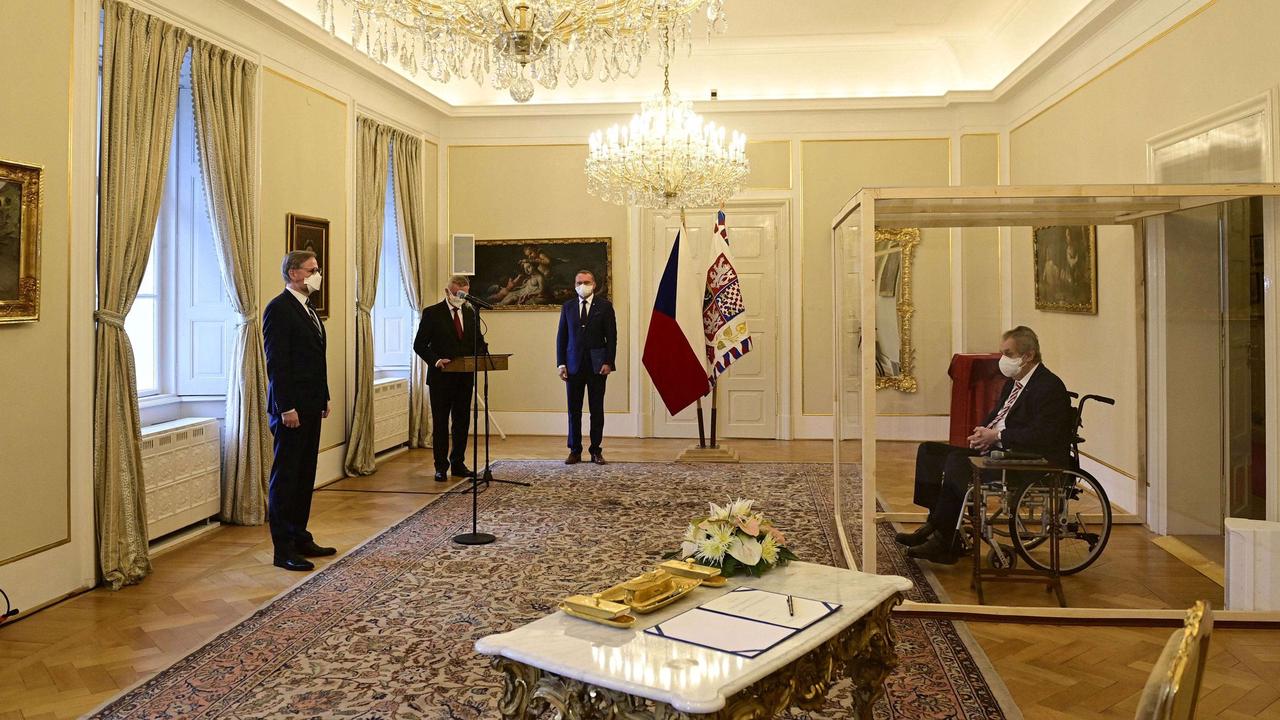 The Czech Republic's president, positive with COVID-19, swore in the country's new prime minister from inside an isolation box