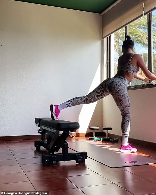 Stylish: Georgina completed the look by wearing white socks over her sportswear, while she added a pop of colour to the look by stepping out in bright pink shoes