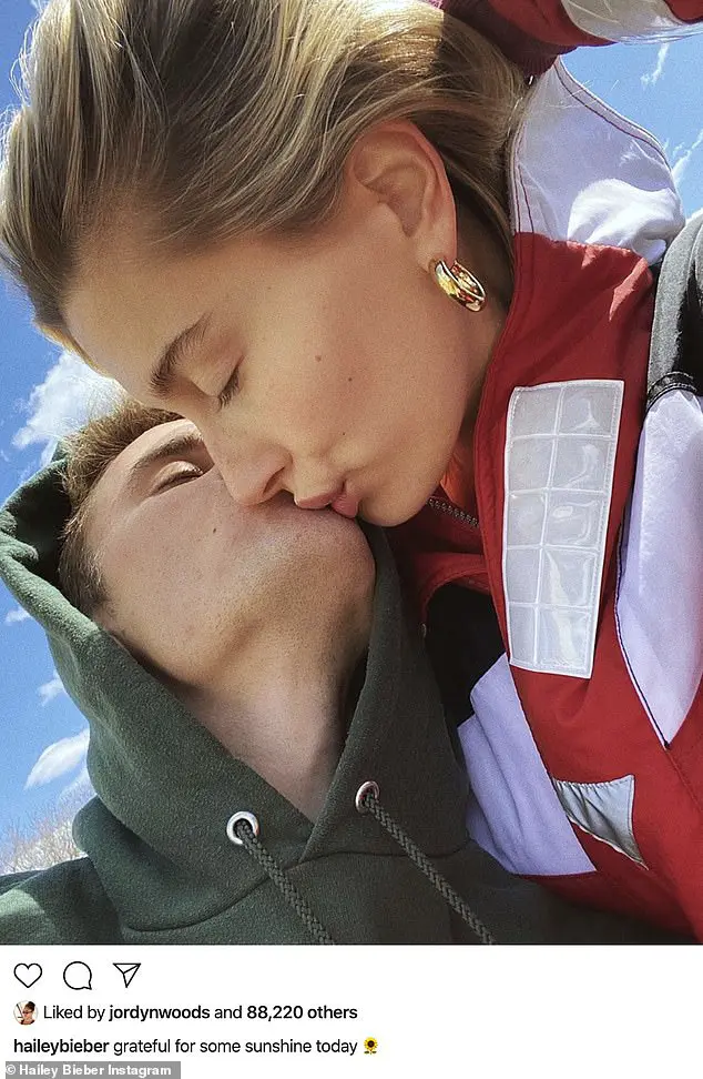 'grateful for some sunshine today': Hailey Bieber, 23, posted a romantic Instagram snapshot Wednesday in which she kissed her husband Justin Bieber, 26