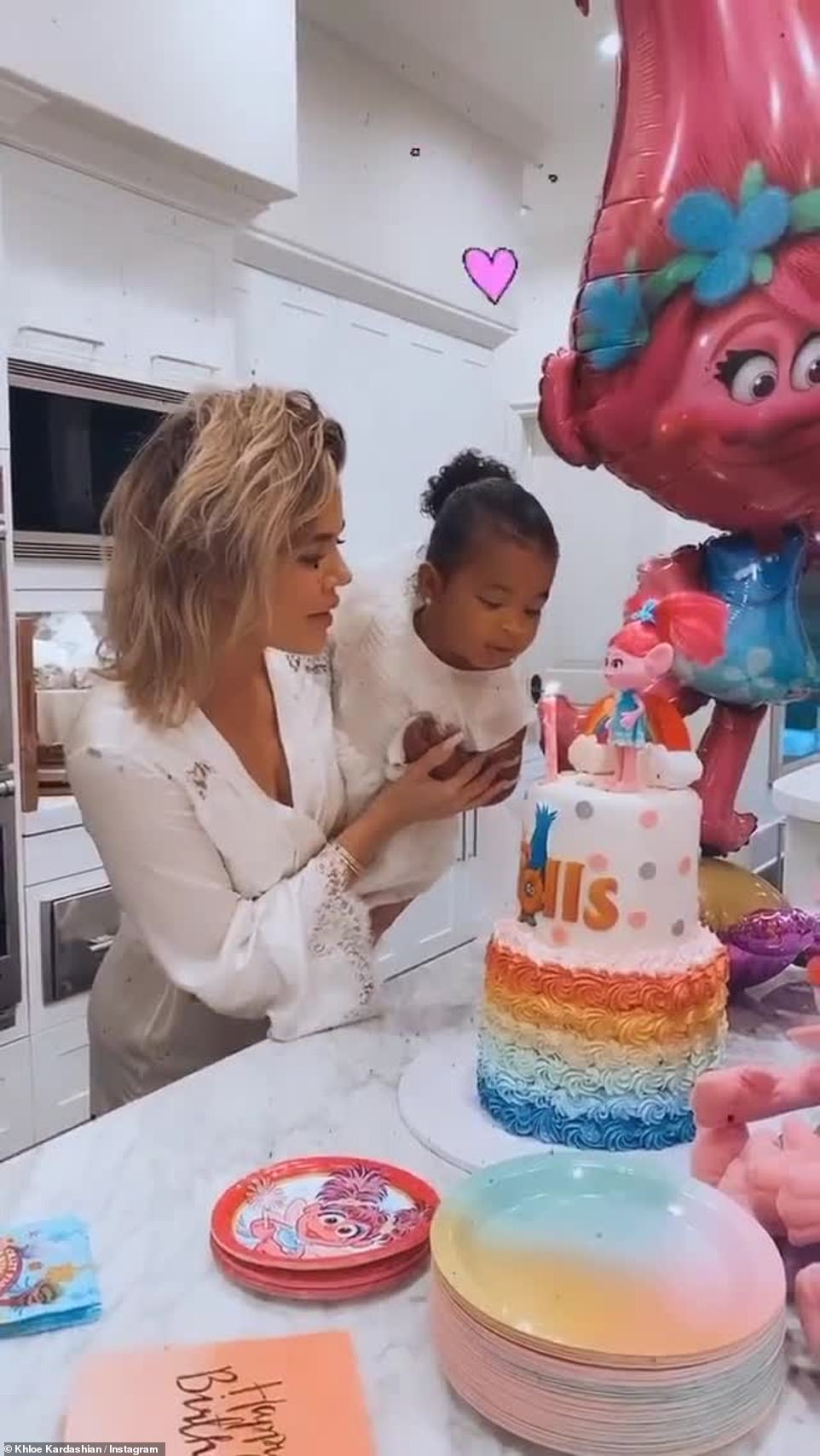 Assist: Her famous mother helped her blow out the candles on an epic Trolls cake
