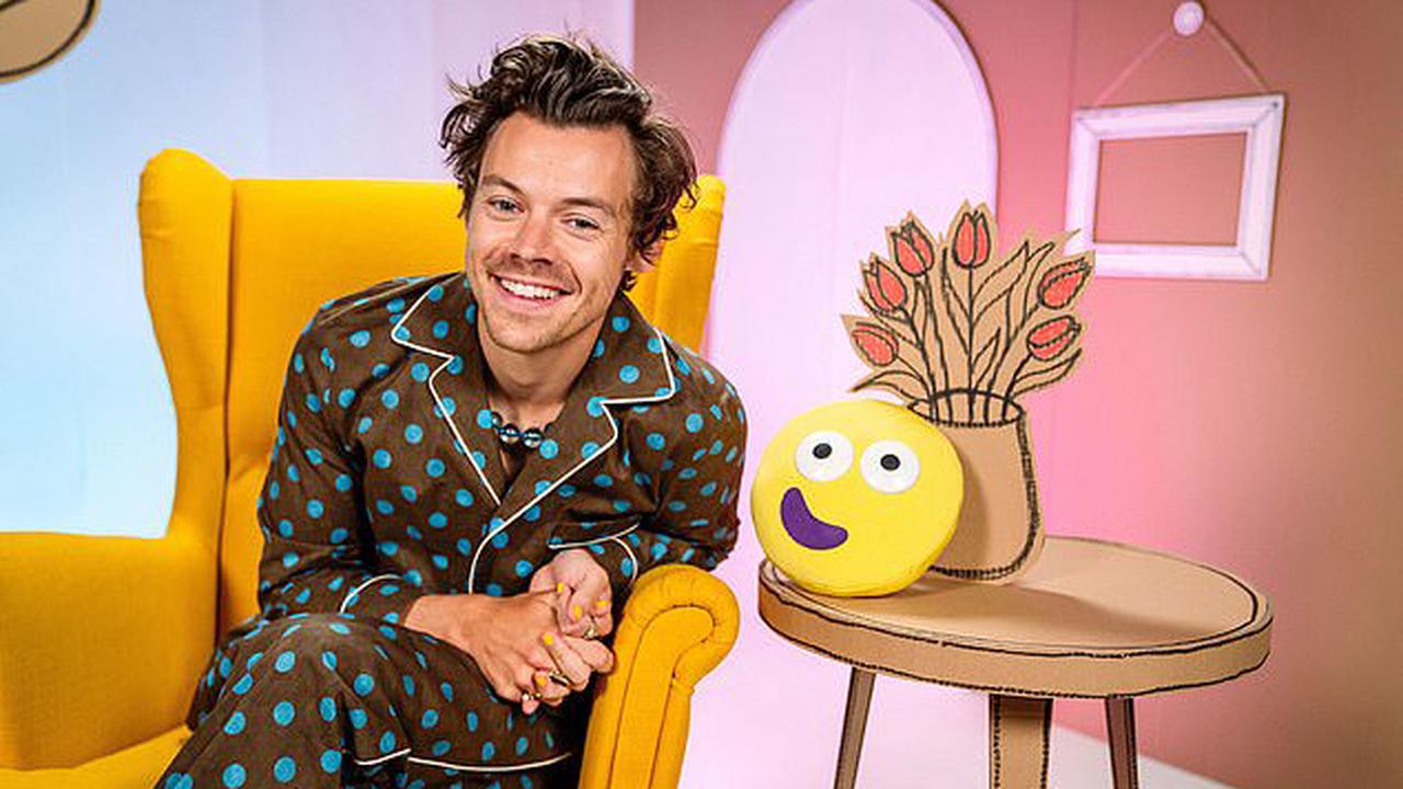 Harry Styles poses in a pair of spotted blue and brown pyjamas in first-look snaps of the star reading on CBeebies Bedtime Stories