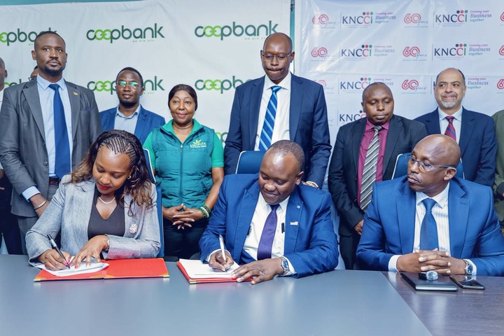 May be an image of one or more people, newsroom, dais and text that says 'apbo coopbank 6@ KNCCI Bustncss Rusiness E cospbank 60.. KNCCI BuSTIeS Husiness 6@ cooesink nk cceA KNCčI Business 6@ coopb KNCCI negether Rusiness KNCON es KNCO 6@ Business ခိ်ါး κΝό'