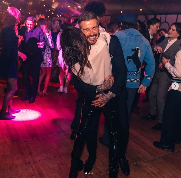 Victoria Beckham could be seen with her arms wrapped around her husband David