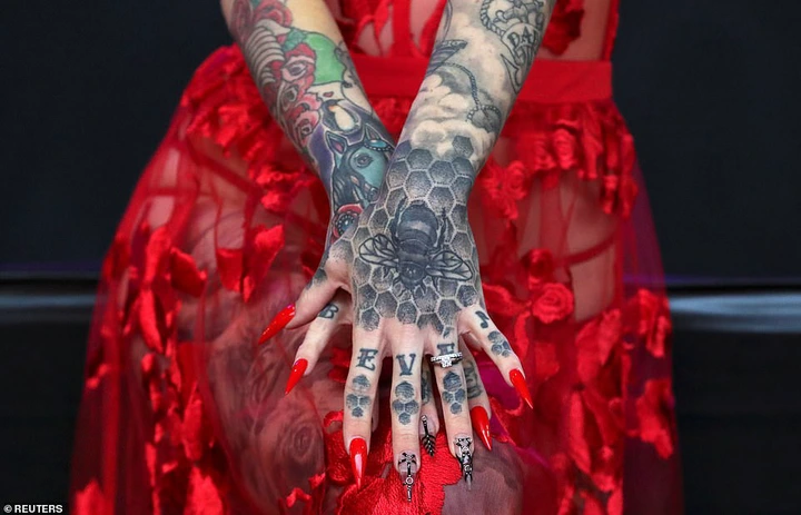 Any tattoos completed at the gathering can then be entered into the convention's own award ceremonies which give prizes in categories that include Best Graphic, Best Healed and Best of Show. Pictured: One woman shows off her tattoo sleeves and hand art