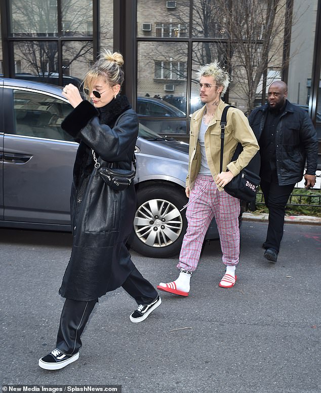 Dressed to impress: Hailey, 23, exuded chic vibes in an all-black ensemble complete with a long leather trench and matching slacks
