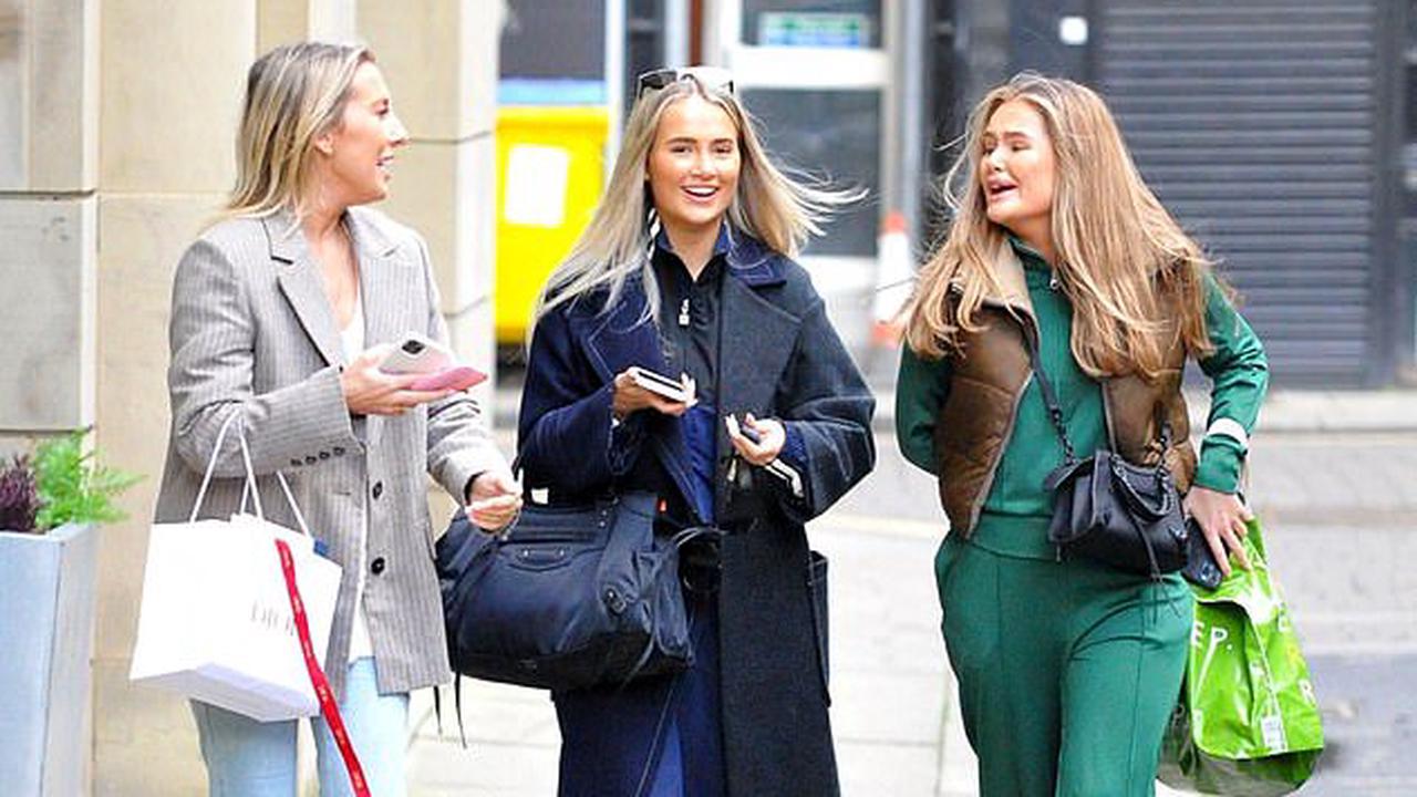 Beaming Molly-Mae Hague totes a £1,750 Balenciaga bag while shopping with her pals - before returning to her Range Rover to find a parking ticket