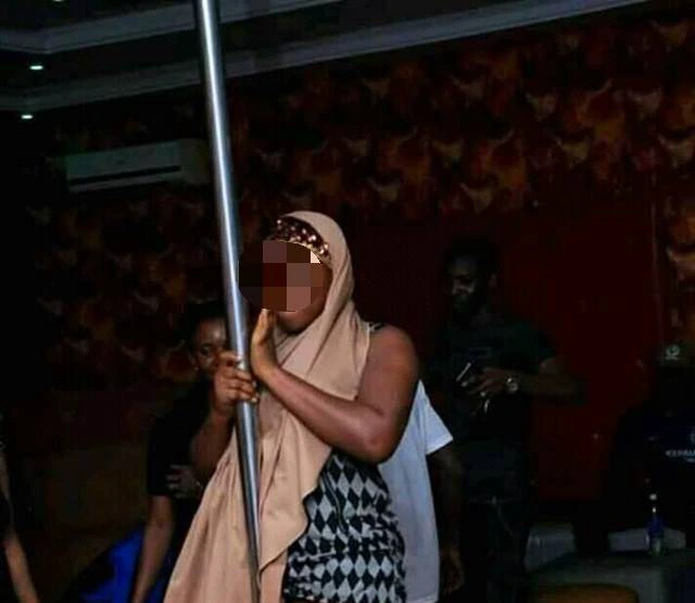 See What A Muslim Lady Wearing Hijab Was Caught Doing At A Night Club (Photos)
