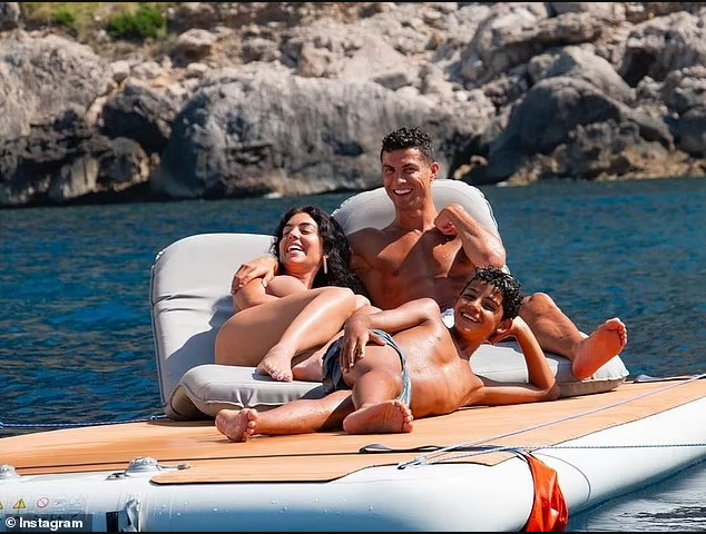 Shirtless Cristiano Ronaldo relaxes in the sun with girlfriend Georgina Rodriguez and his children during boat trip in Majorca (photos)