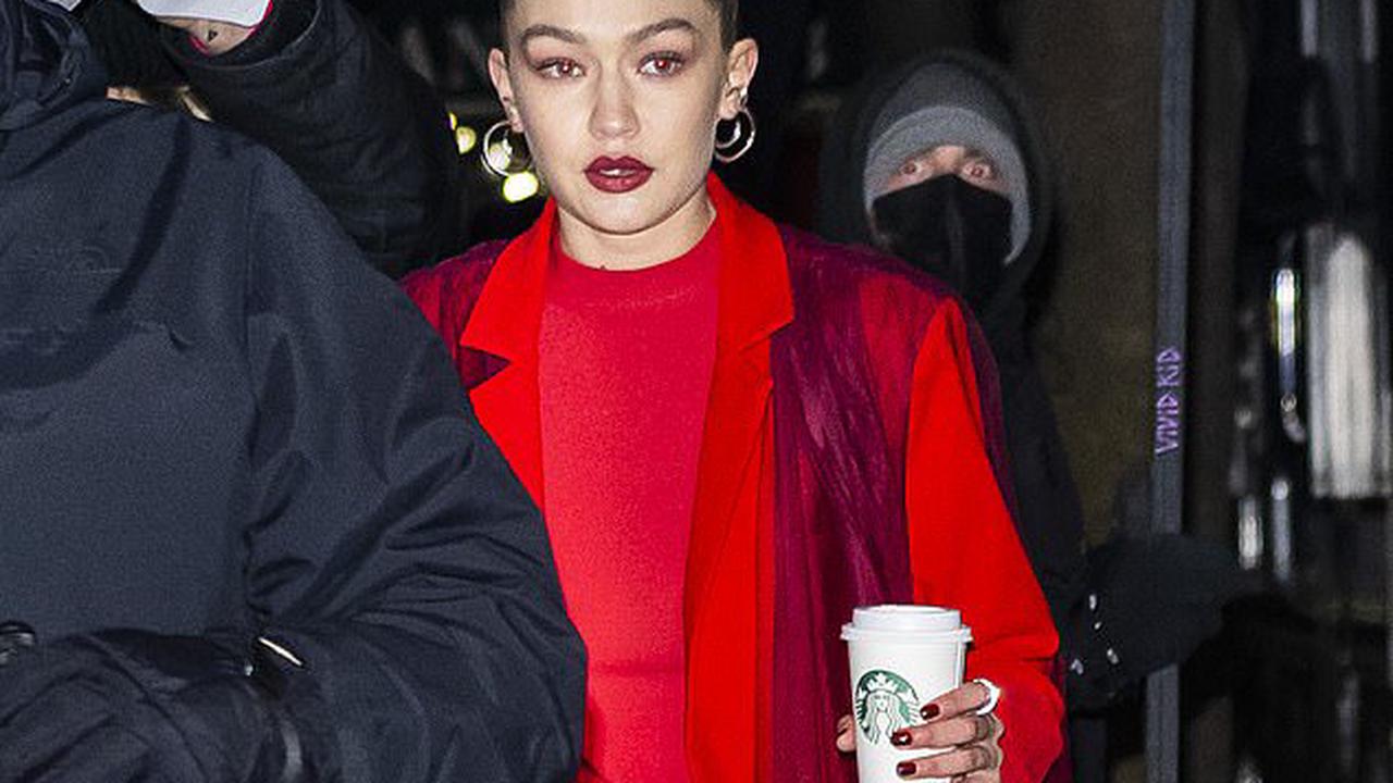 Gigi Hadid is a vision in an all-red outfit and bold scarlet lip as she makes her way to a Maybelline photo shoot in NY