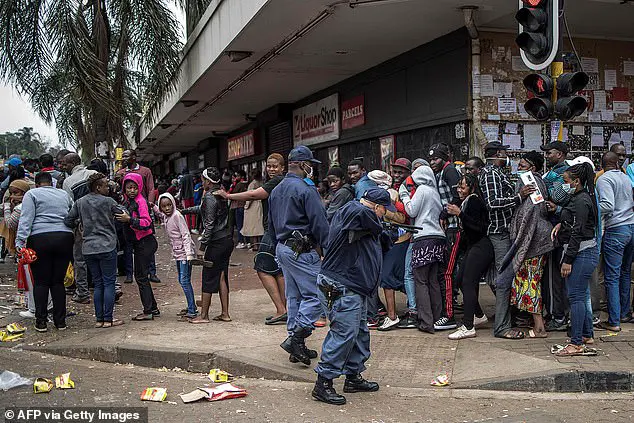 A South African policeman points his pump rifle to disperse a crowd of shoppers in Yeoville, Johannesburg, on Sunday