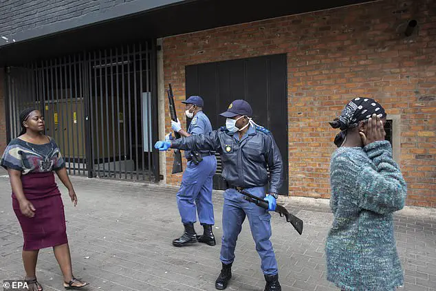 Members of the SAP (South African Police Force) instruct citizens to stand in line according to the social distances regulations on day 2 of the 21 day national lockdown following President Cyril Ramaphosa's declaration of a National Disaster as a result of COVID-19