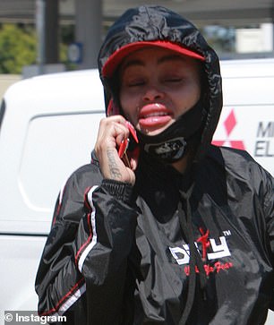She had to wait her turn outside the bank due to mandatory social distancing rules, sitting on a curb as she waited to enter, the source said