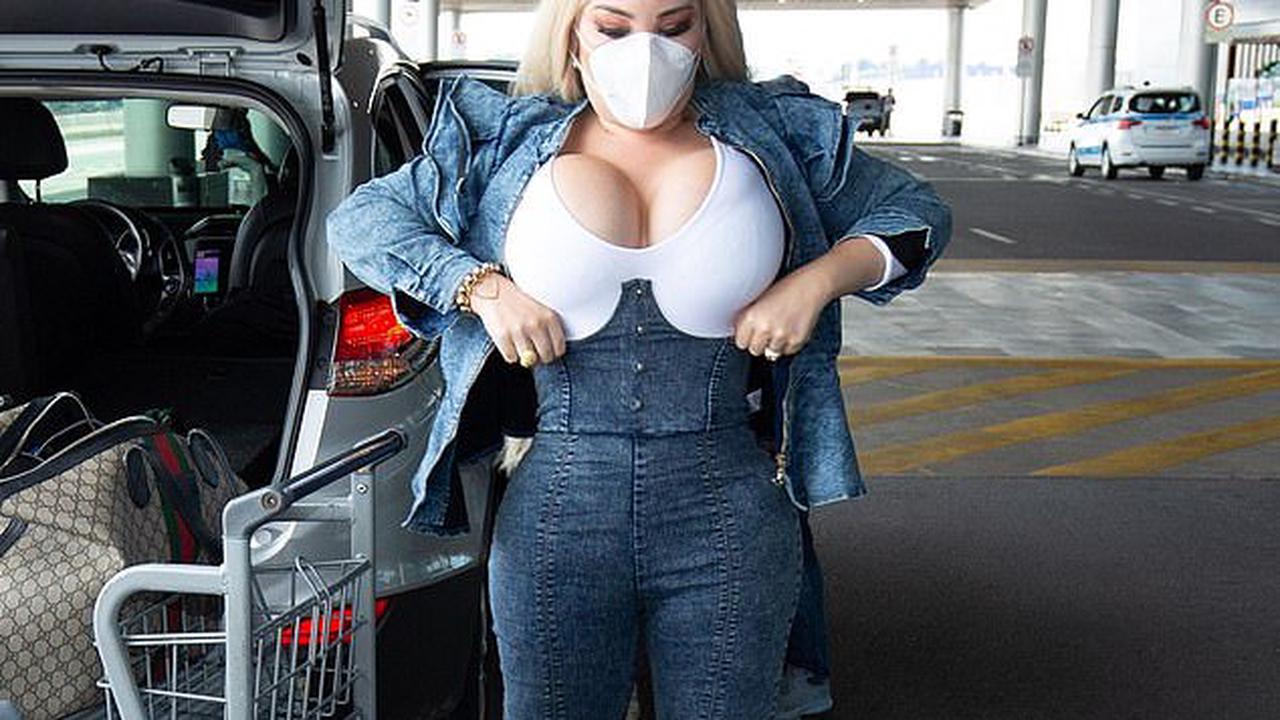 Jessica Alves puts on VERY busty display in cleavage enhancing top and corset as she flies to the UK after revealing she's considering voice feminisation surgery